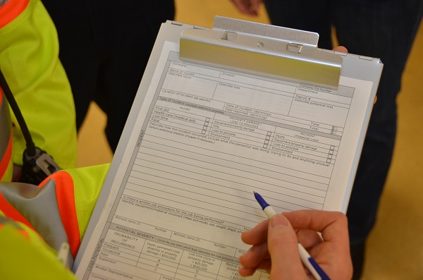 Worker completing form on a clipboard