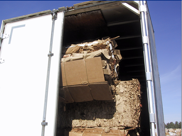 Unloading trucks - leaning bale