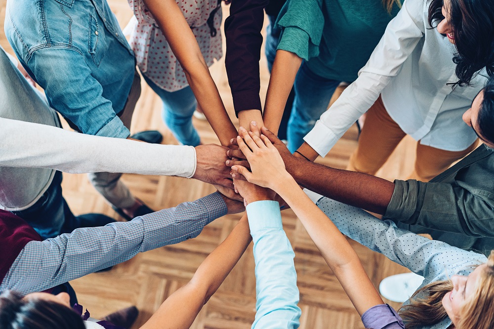 hands in centre of a group huddle