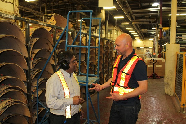 Worker and supervisor talk at industrial plant