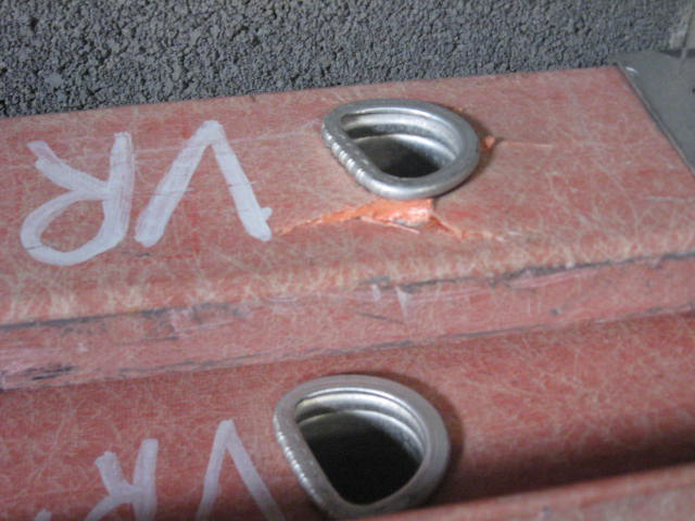 Small cracks in the fiberglass adjacent to the ladder rung