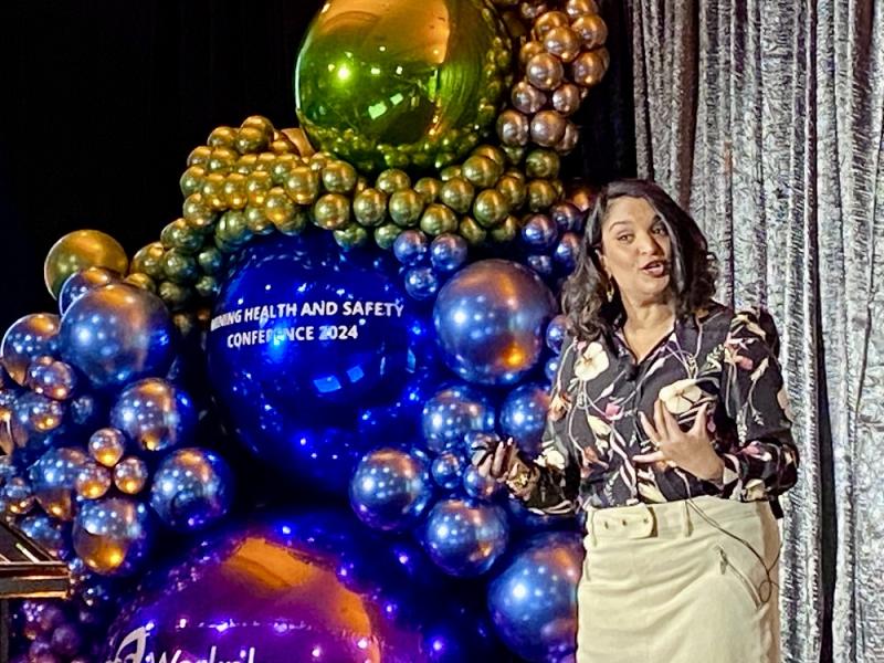 Woman speaking onstage at conference