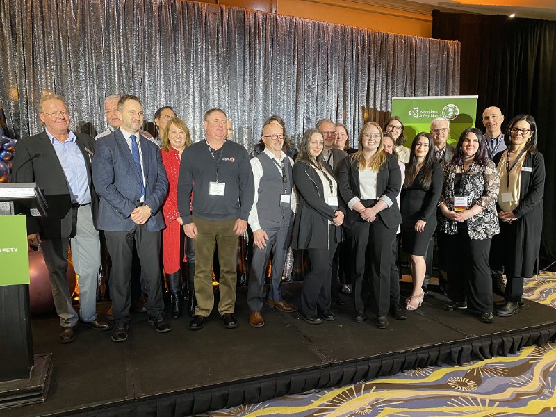 Large group of people standing on conference stage