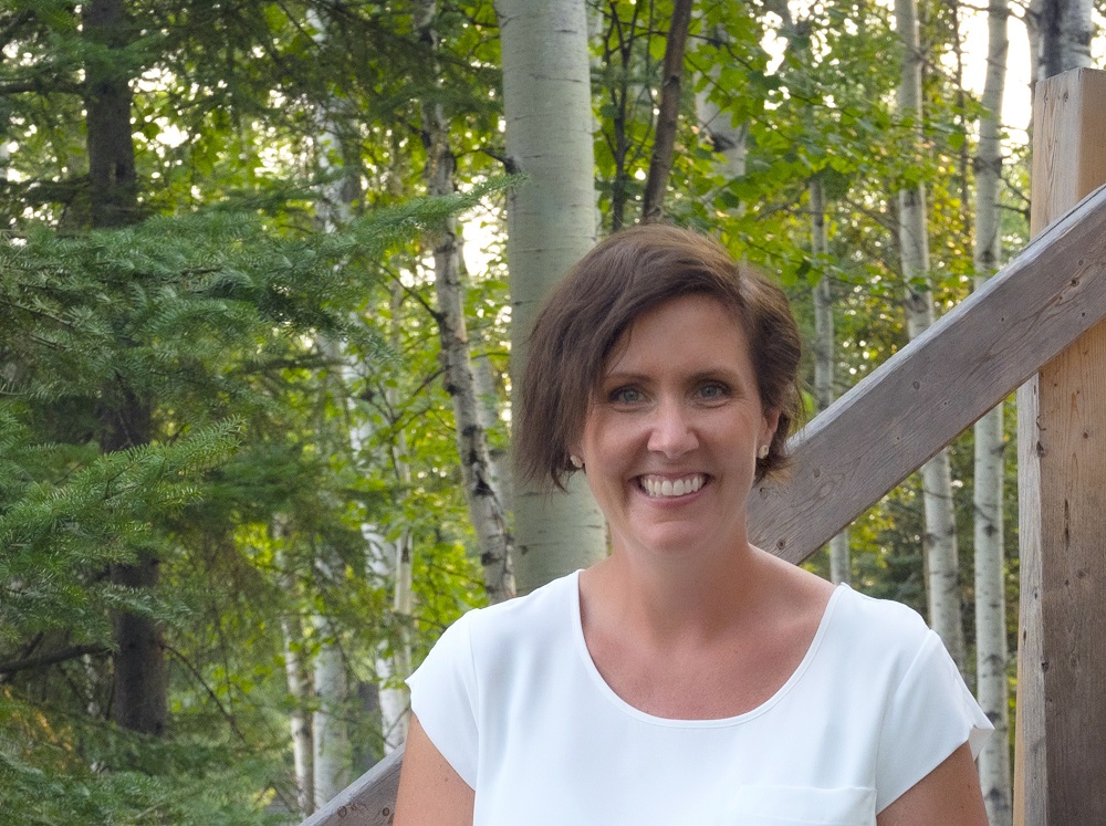 Woman sitting on outdoor steps in forest setting