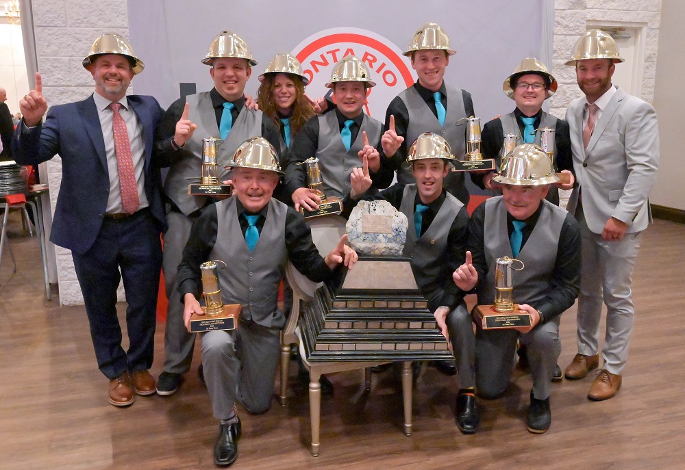 Group of people wearing gold hard hats